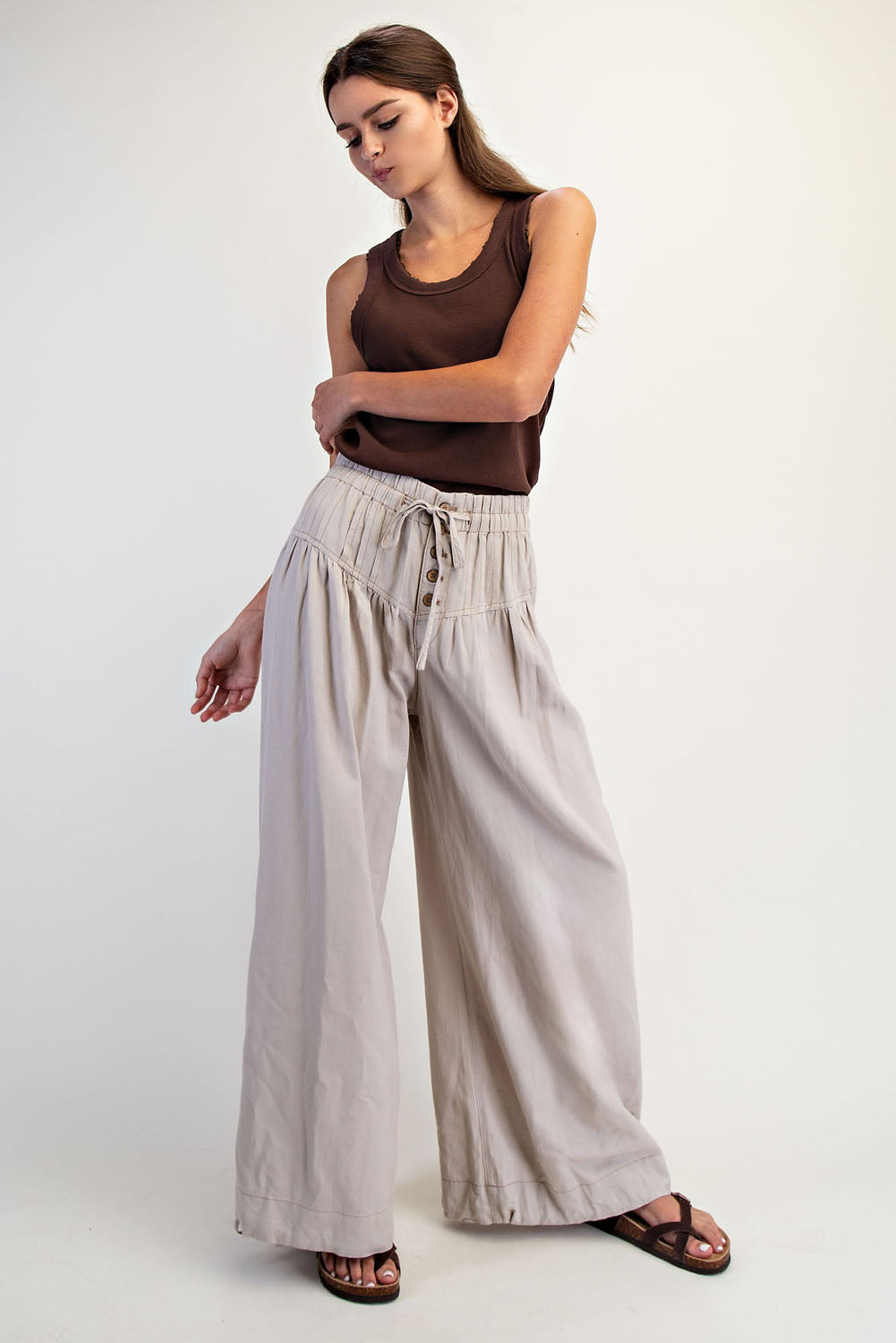 The Racheal Linen Blend Pants in Sand — front view, pleated wide-leg silhouette with button-up closure