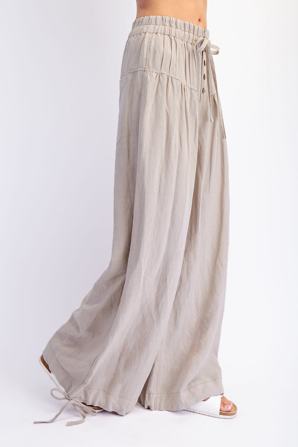 The Racheal Linen Blend Pants in Sand — side view, flowy wide-leg fit with smocked elastic waist