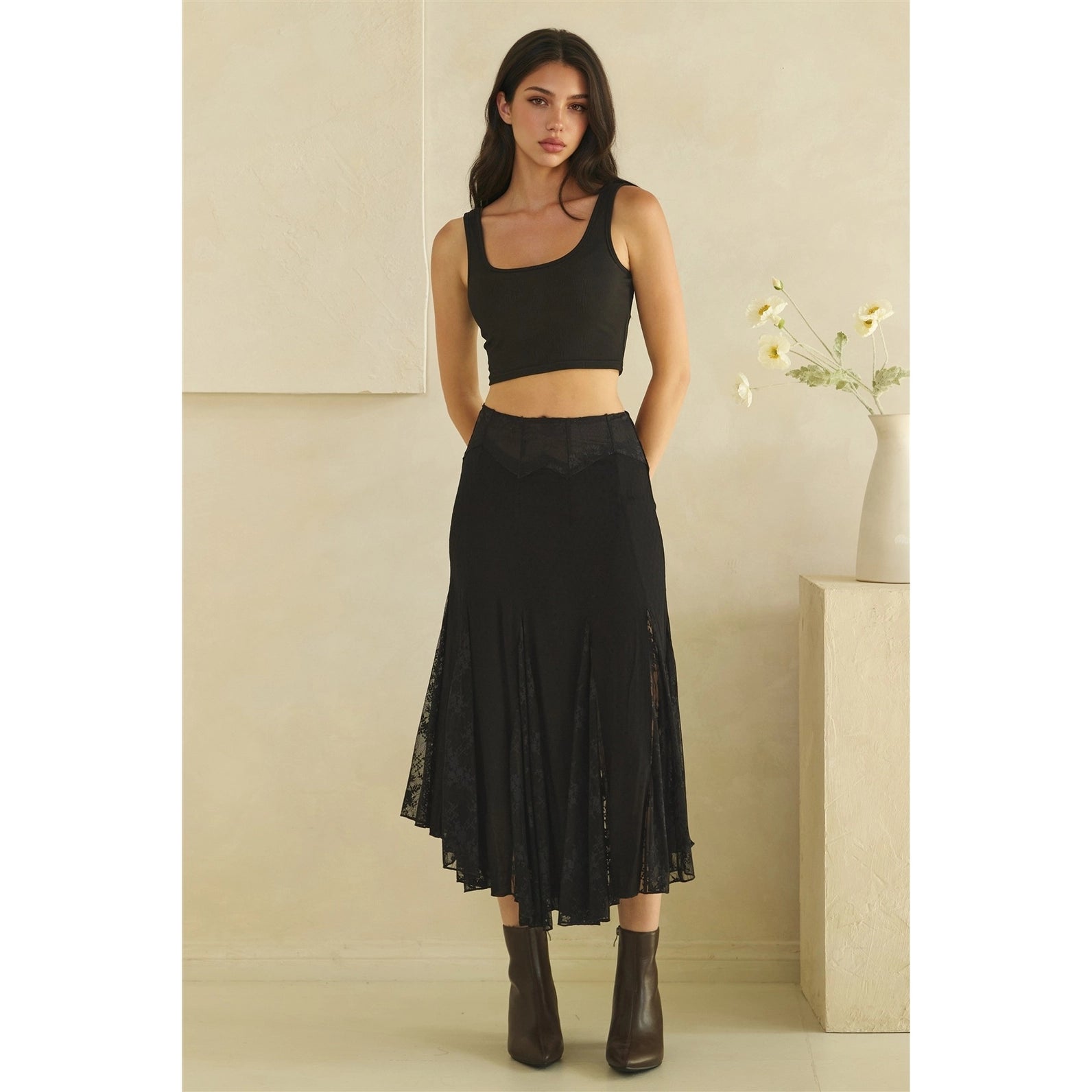 Calla Lace Godet Maxi Skirt in Black by Oli & Hali — full length front view on model, black godet skirt with structured waistband and sheer floral lace panel inserts, black crop top and boots