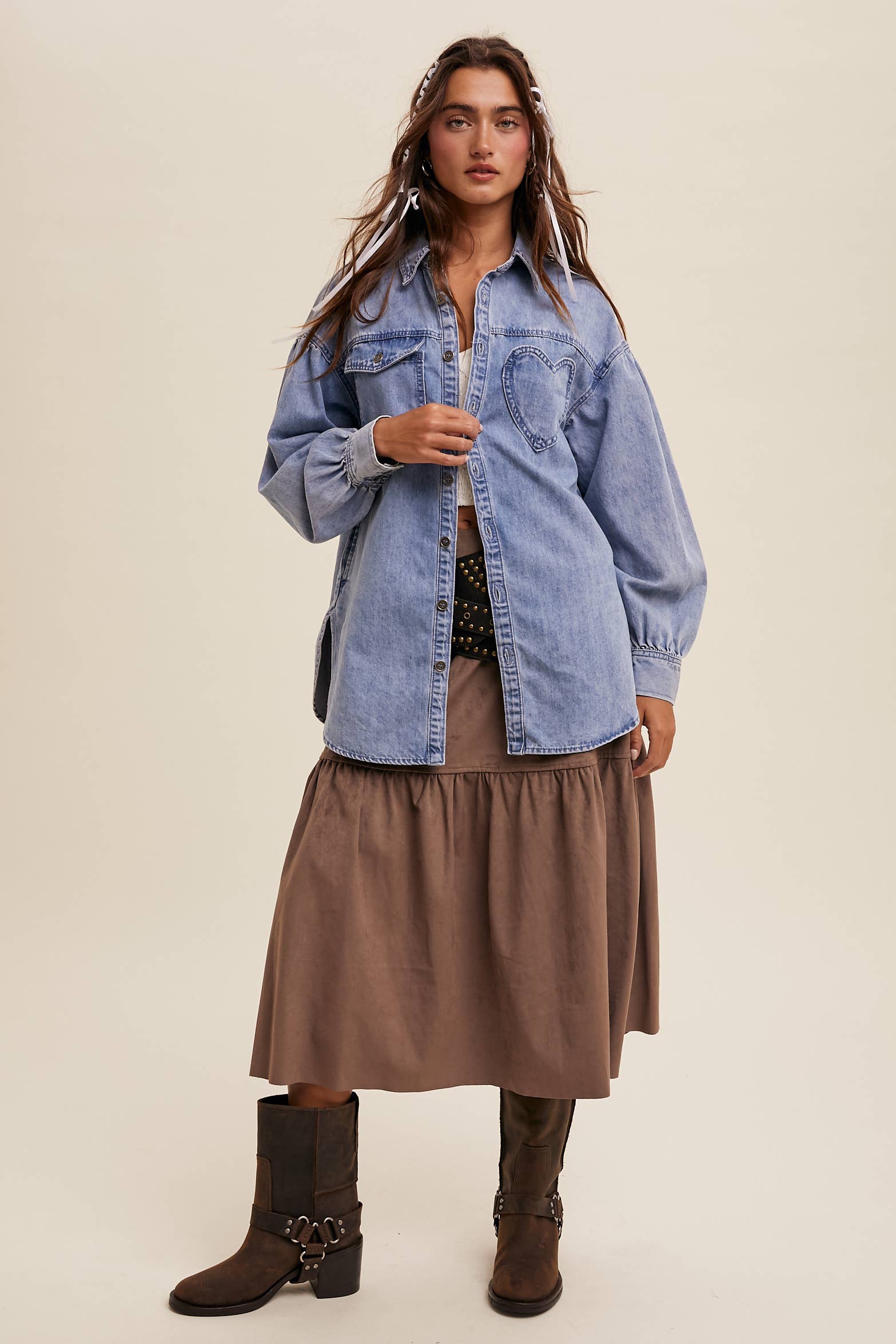 Light-wash oversized denim shacket with a heart-shaped chest pocket, button front, drop shoulders, balloon sleeves, and a curved hem.