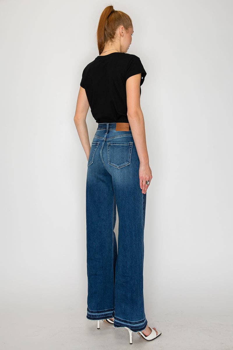 Flare jeans hem detail - unique polished hem treatment on dramatic long flare silhouette. Back view