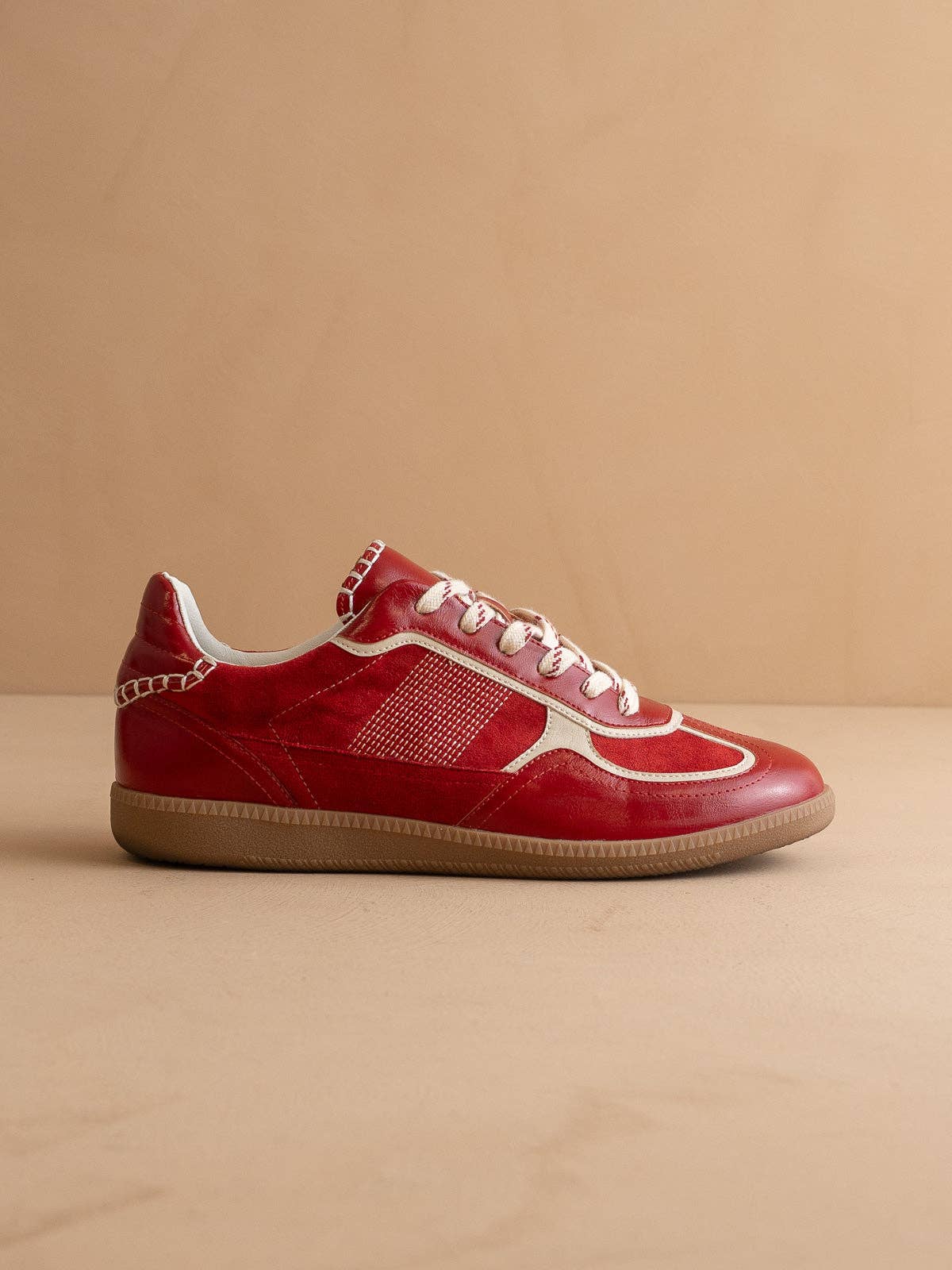 Cherry red Oasis Society sneakers with cream detailing and two lace options — organza ribbon and classic cotton.