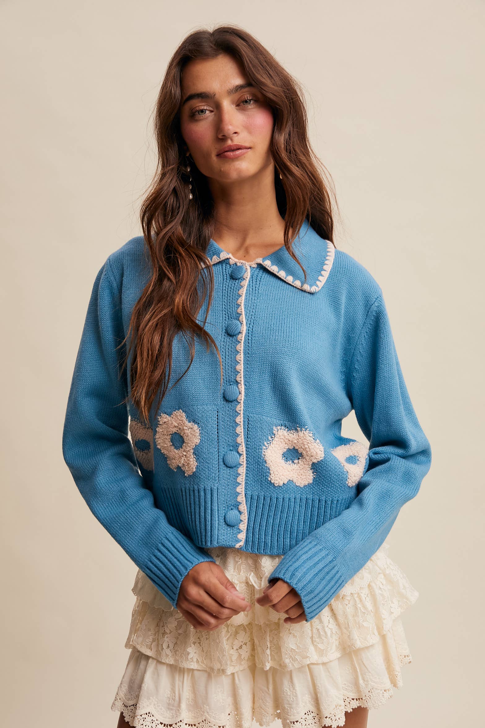 Women’s floral collar knit cardigan with button-front design, soft textured fabric, and contrast flower-patterned collar — stylish layering sweater for everyday wear.