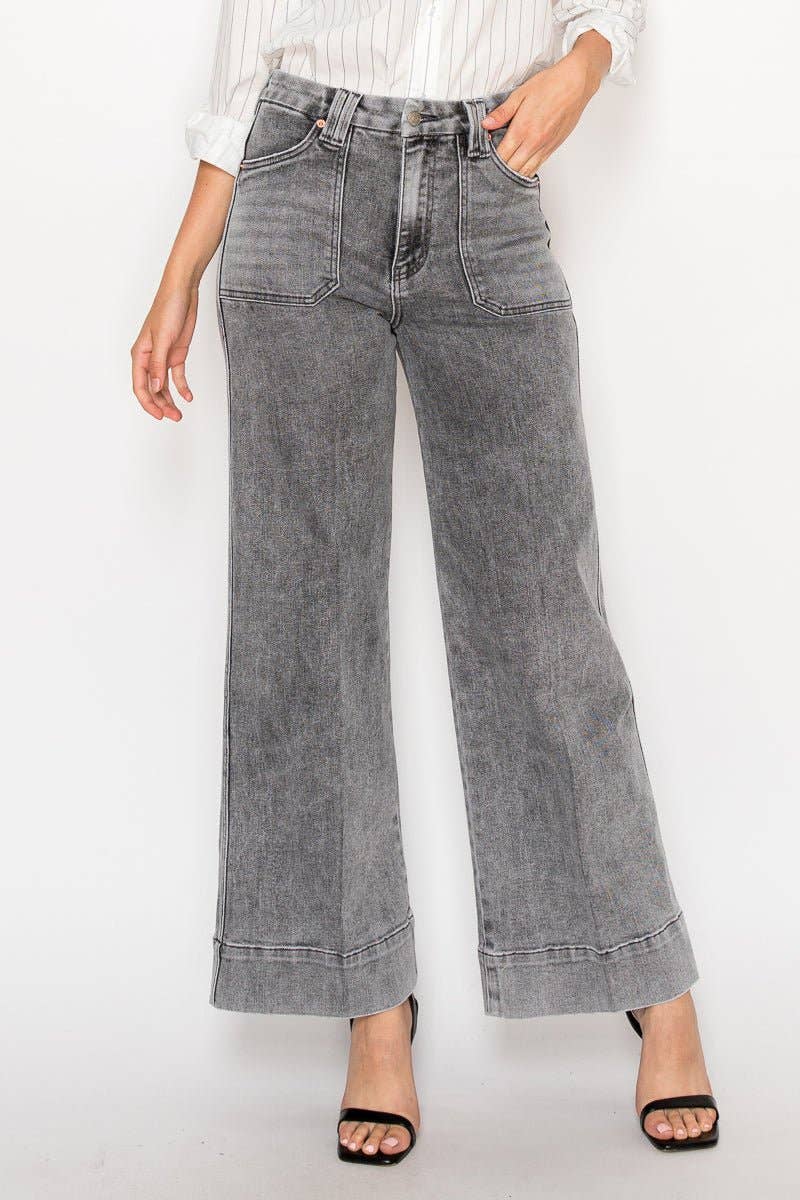 Person wearing gray wide-leg jeans on a white background