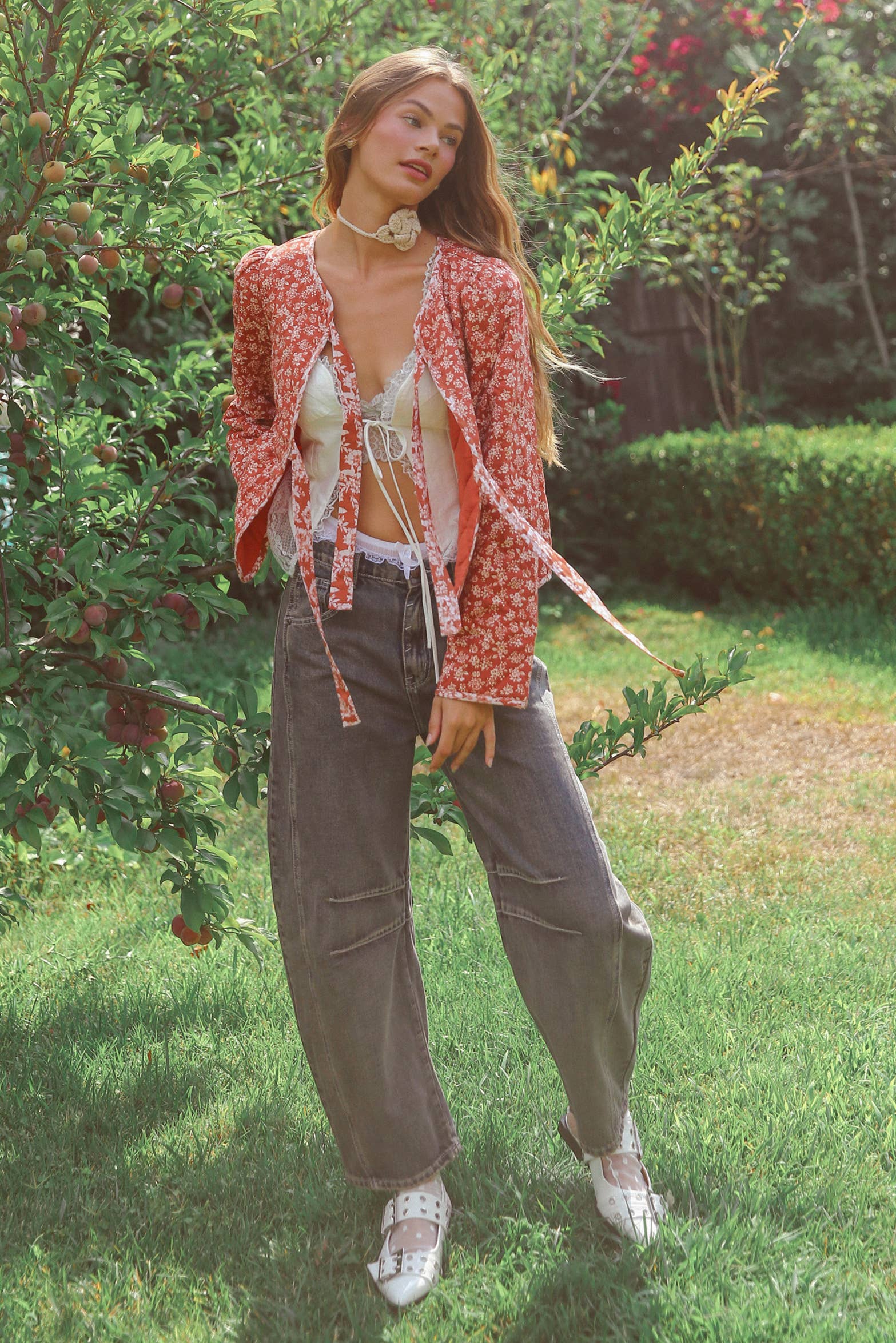 Dark wash wide-leg jeans with relaxed fit, seam detailing across the knees, and a high-rise waist, styled with brown ankle boots.