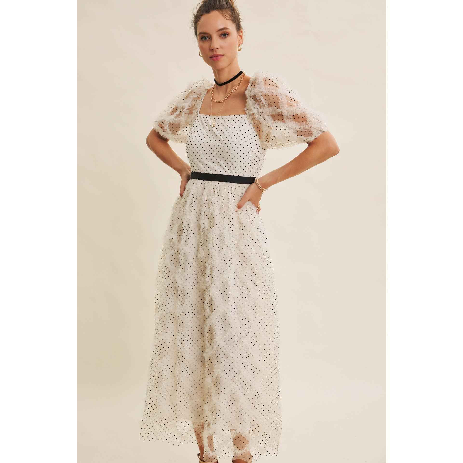 Front view — cream polka-dot tulle midi dress with puff sleeves, square neckline, and black waist belt on model.