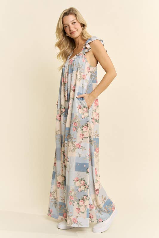 Side view Model wearing vintage floral wide-leg jumpsuit in blue – lifestyle shot