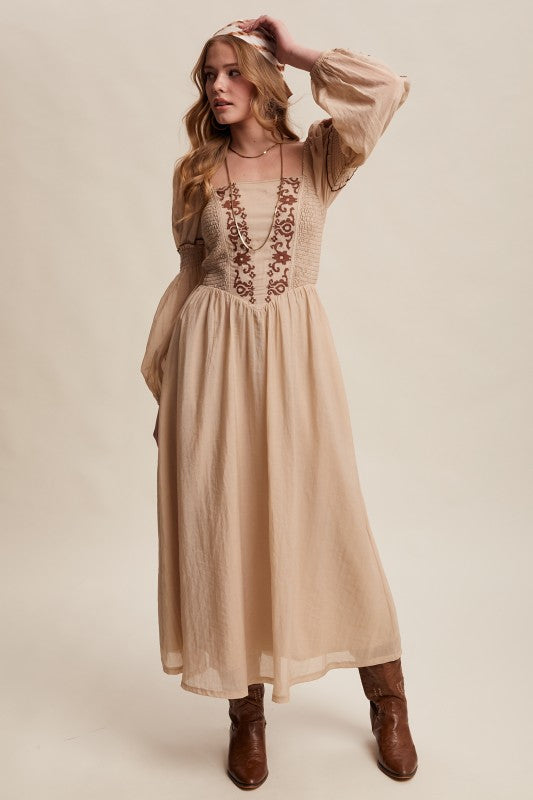 Beige long-sleeve boho maxi dress with puff sleeves and embroidered bodice.