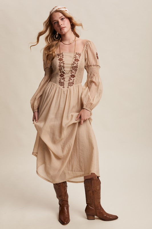 Beige long-sleeve boho maxi dress with puff sleeves and embroidered bodice.