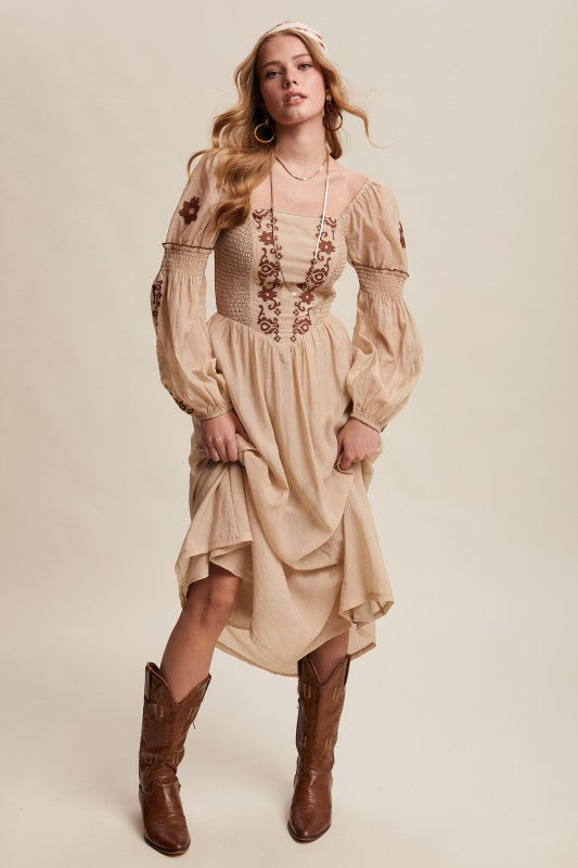 Beige long-sleeve boho maxi dress with puff sleeves and embroidered bodice.