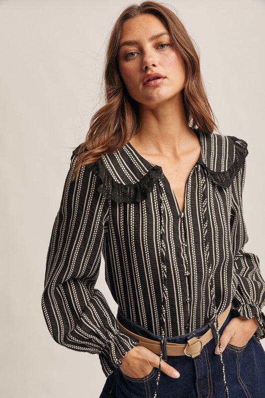 Black vertical-striped long-sleeve blouse with lace ruffle collar and button front.