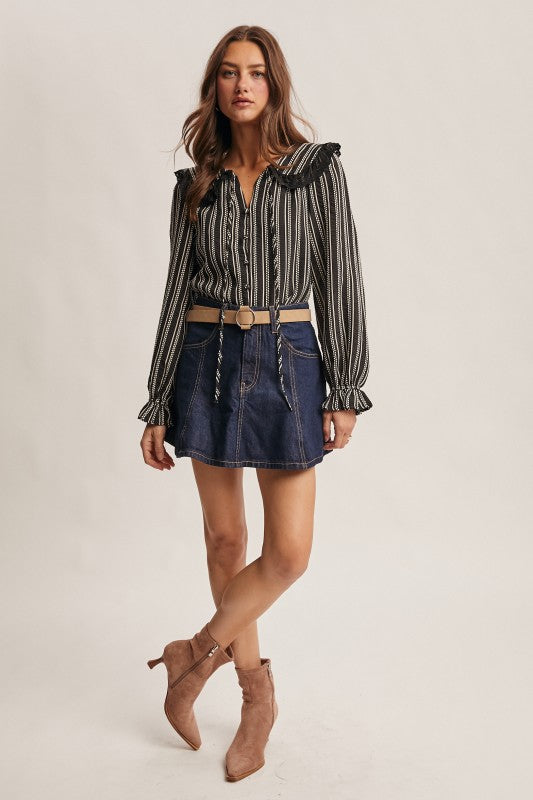Black vertical-striped long-sleeve blouse with lace ruffle collar and button front.