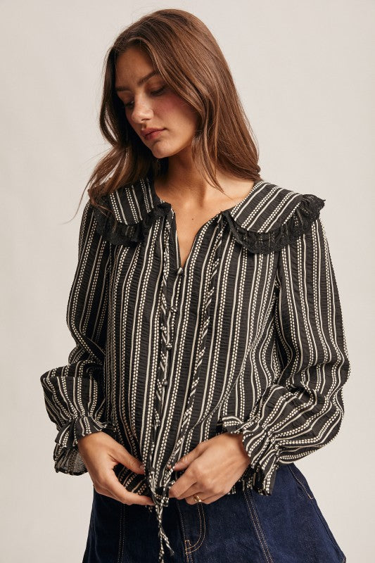 Black vertical-striped long-sleeve blouse with lace ruffle collar and button front.