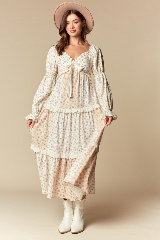 Cream/blush ditsy floral tiered maxi dress, ruffle trim, long puff sleeves, tie-front sweetheart neckline, front view on model.