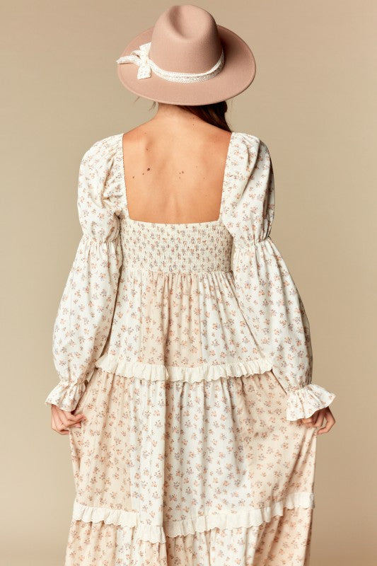 Back view—cream/blush ditsy floral tiered maxi dress with smocked back, square neckline, long puff sleeves, ruffle trim.