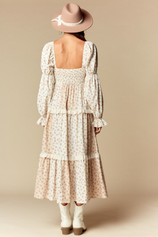 Back view—cream/blush ditsy floral tiered maxi dress with smocked back, square neckline, long puff sleeves, ruffle trim.