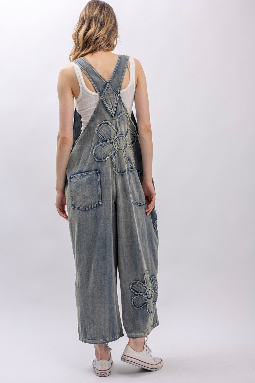 crossback straps, daisy appliqué on bib and legs, back patch pockets