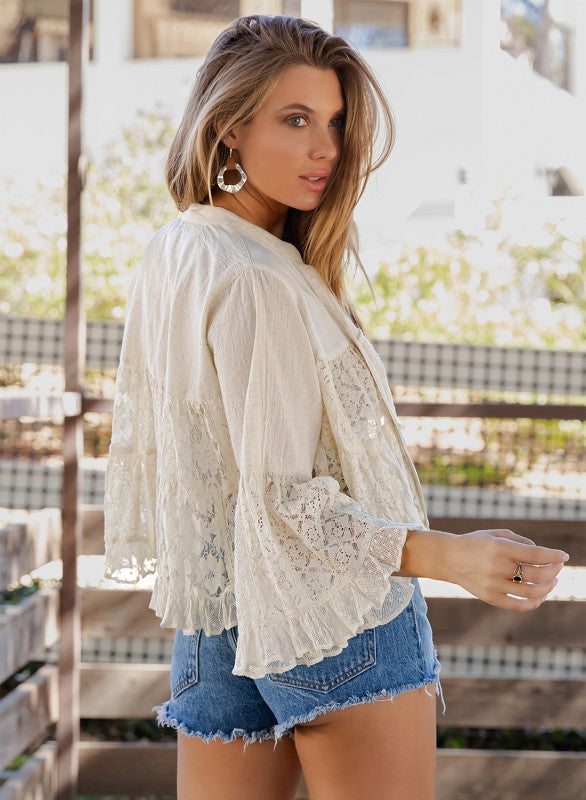 The Bohemian Breeze Lace Shrug styled over denim - lightweight neutral layering piece with boho-luxe appeal