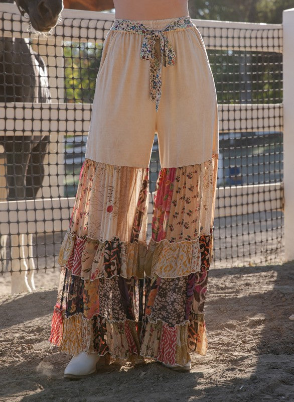 The Dreamer Tiered Wide Leg Pants - close-up of multi-tiered ruffle construction and printed fabric layers