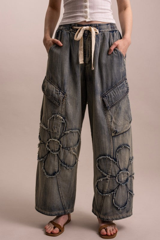 Garment-washed wide leg cargo pants with raw-edge flower appliqués and cargo pockets — boho denim