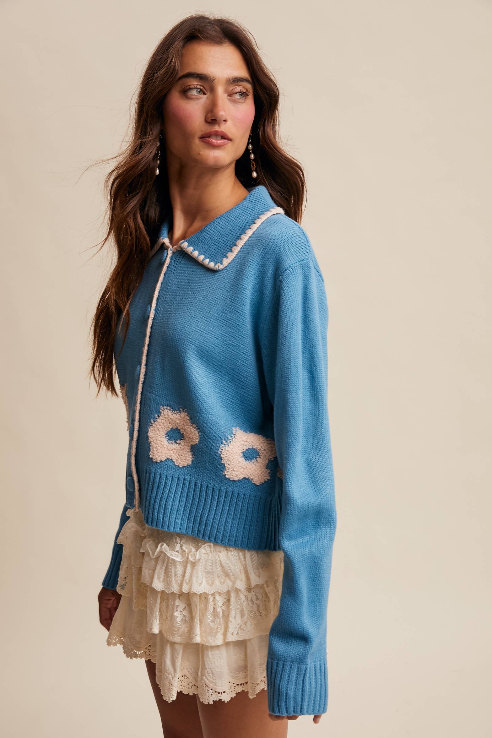 Women’s floral collar knit cardigan with button-front design, soft textured fabric, and contrast flower-patterned collar — stylish layering sweater for everyday wear.