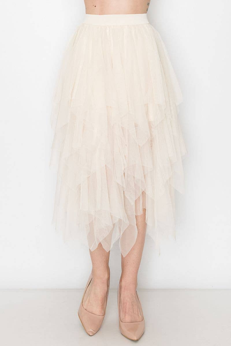 Beige tulle skirt worn by a person on a white background