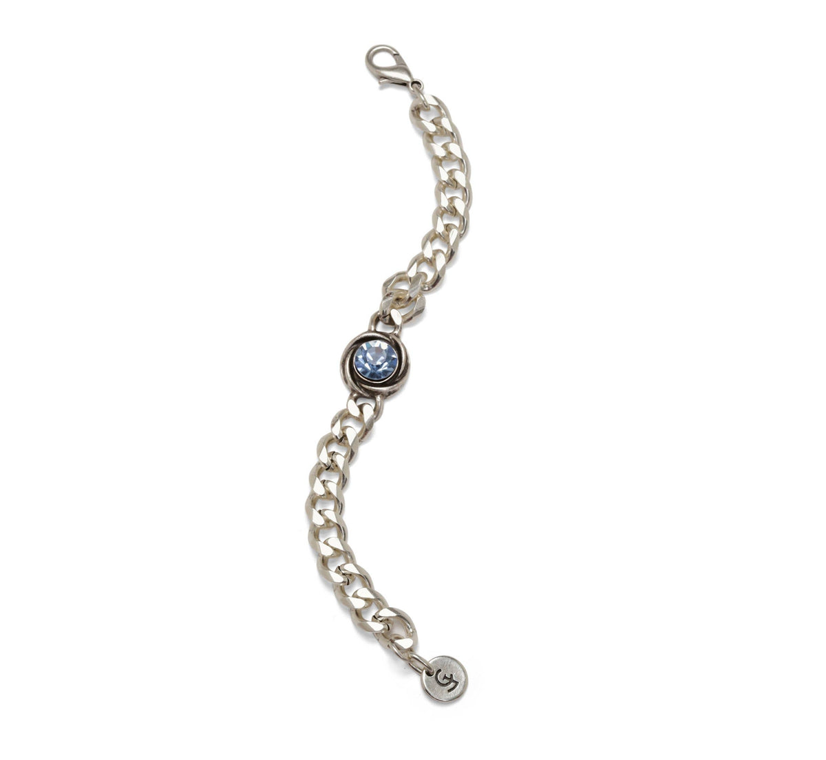 A silver chain bracelet featuring a central bezel-set round blue gemstone and a small round charm at the end, shown on a plain white background.