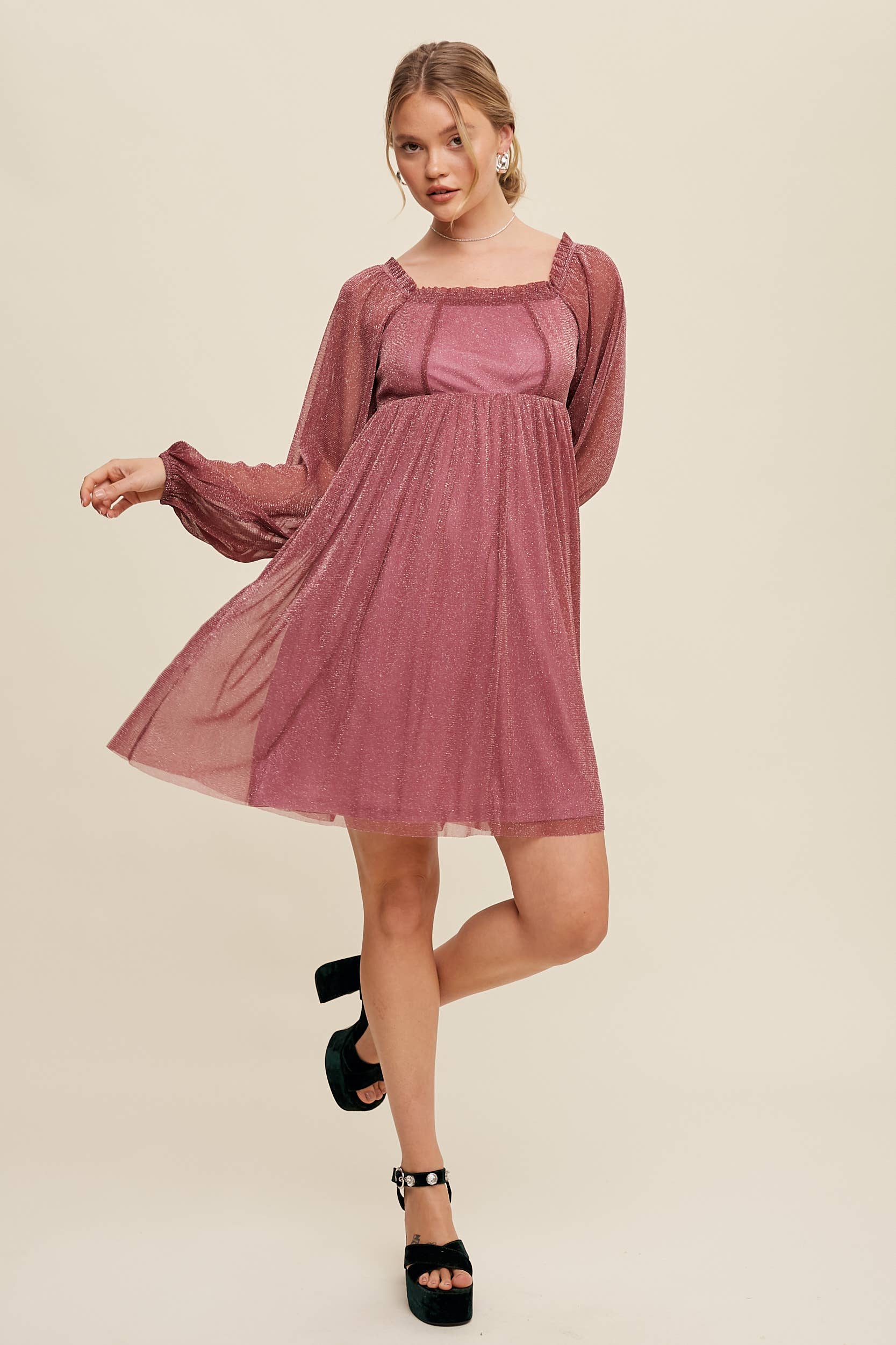 Model wearing a mauve shimmer mini dress with long sheer sleeves, square neckline, and flowy A-line silhouette — romantic sparkle party dress