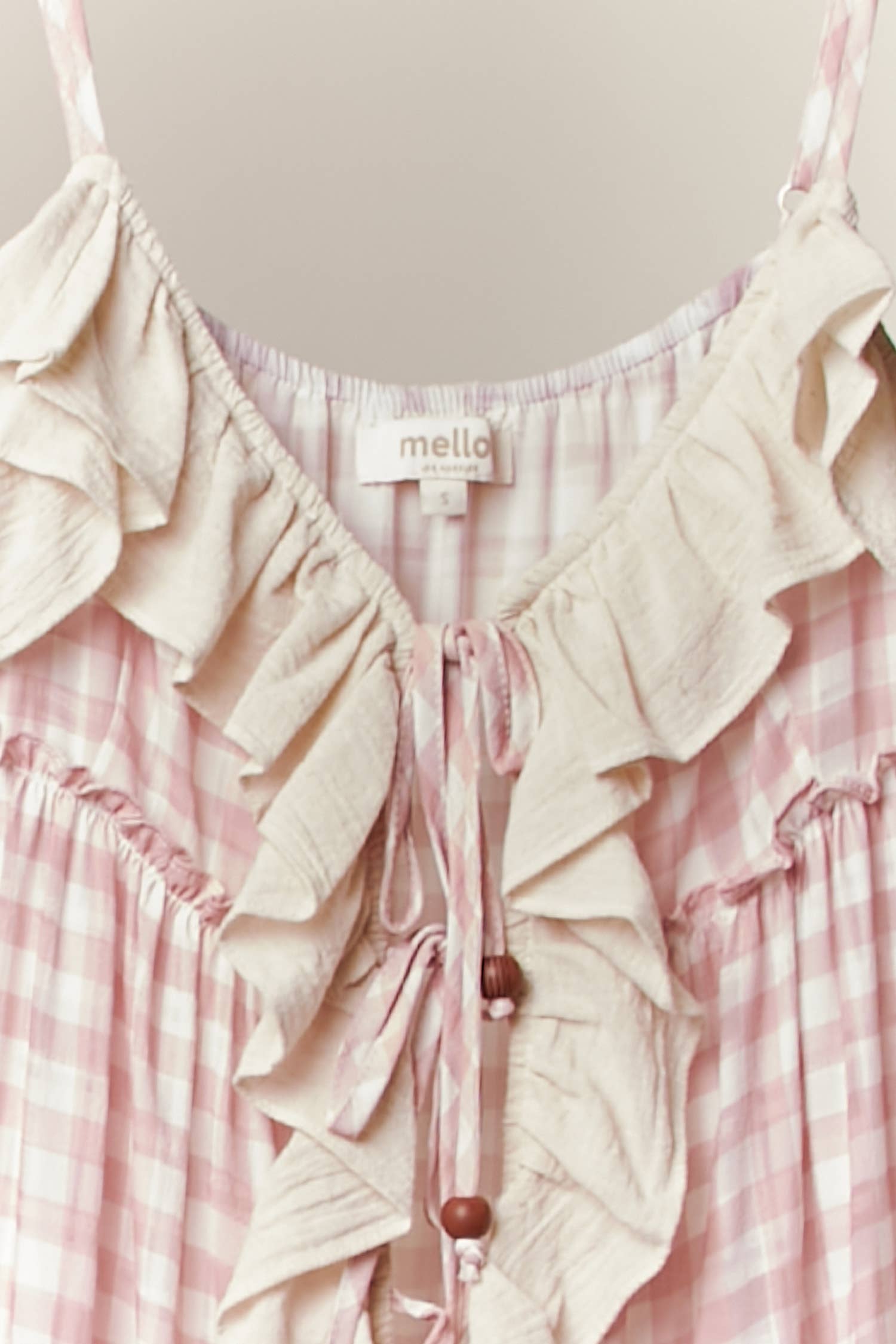 Pink ruffle cardigan dress detail - close-up of luxurious flowing fabric and cascading ruffle construction