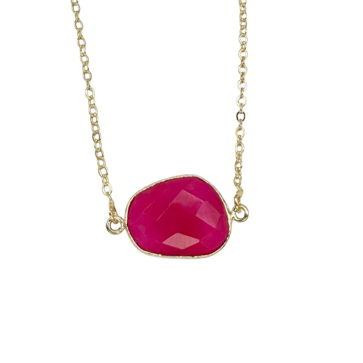Necklace with a pink stone and gold chain on a white background