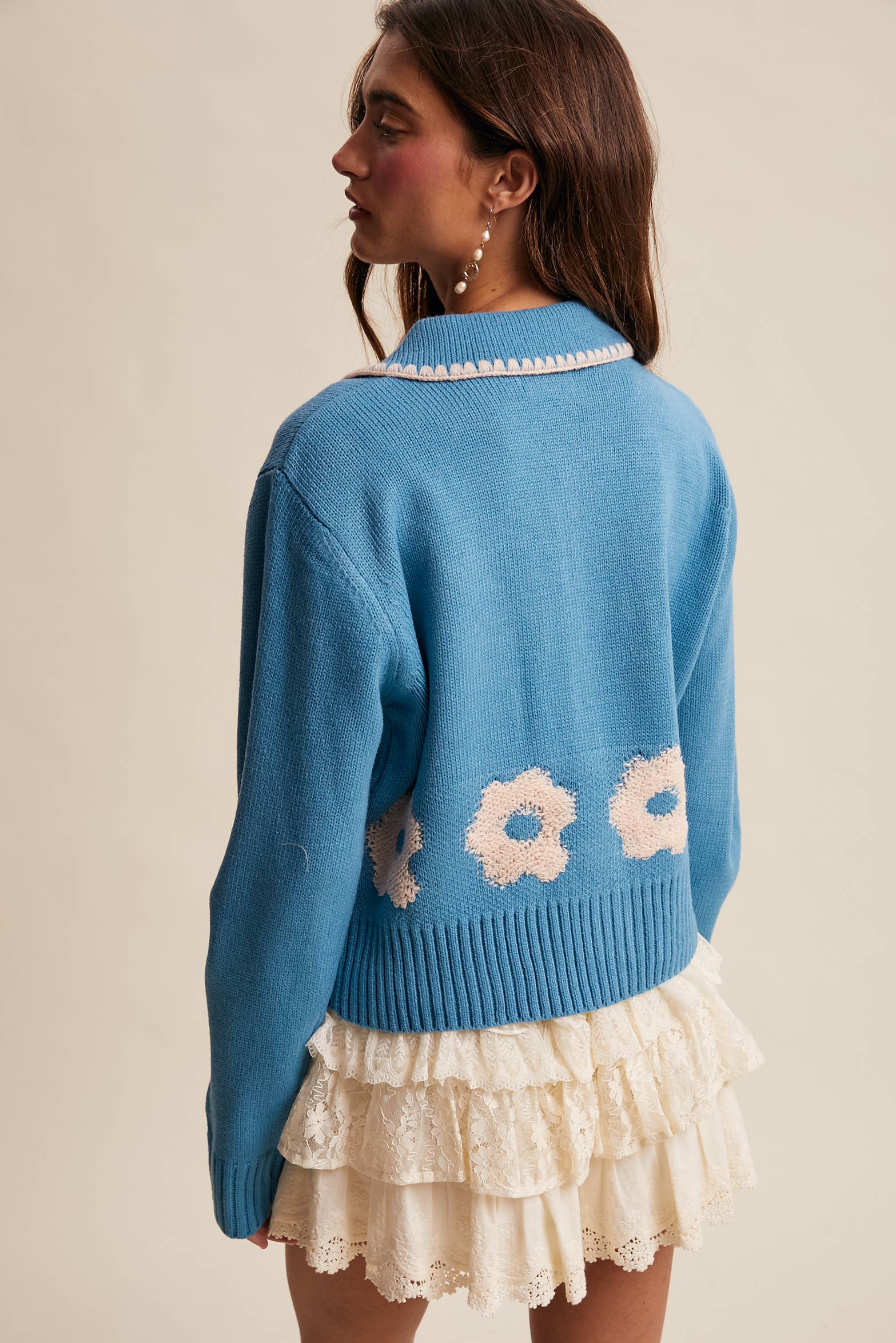 Women’s floral collar knit cardigan with button-front design, soft textured fabric, and contrast flower-patterned collar — stylish layering sweater for everyday wear.