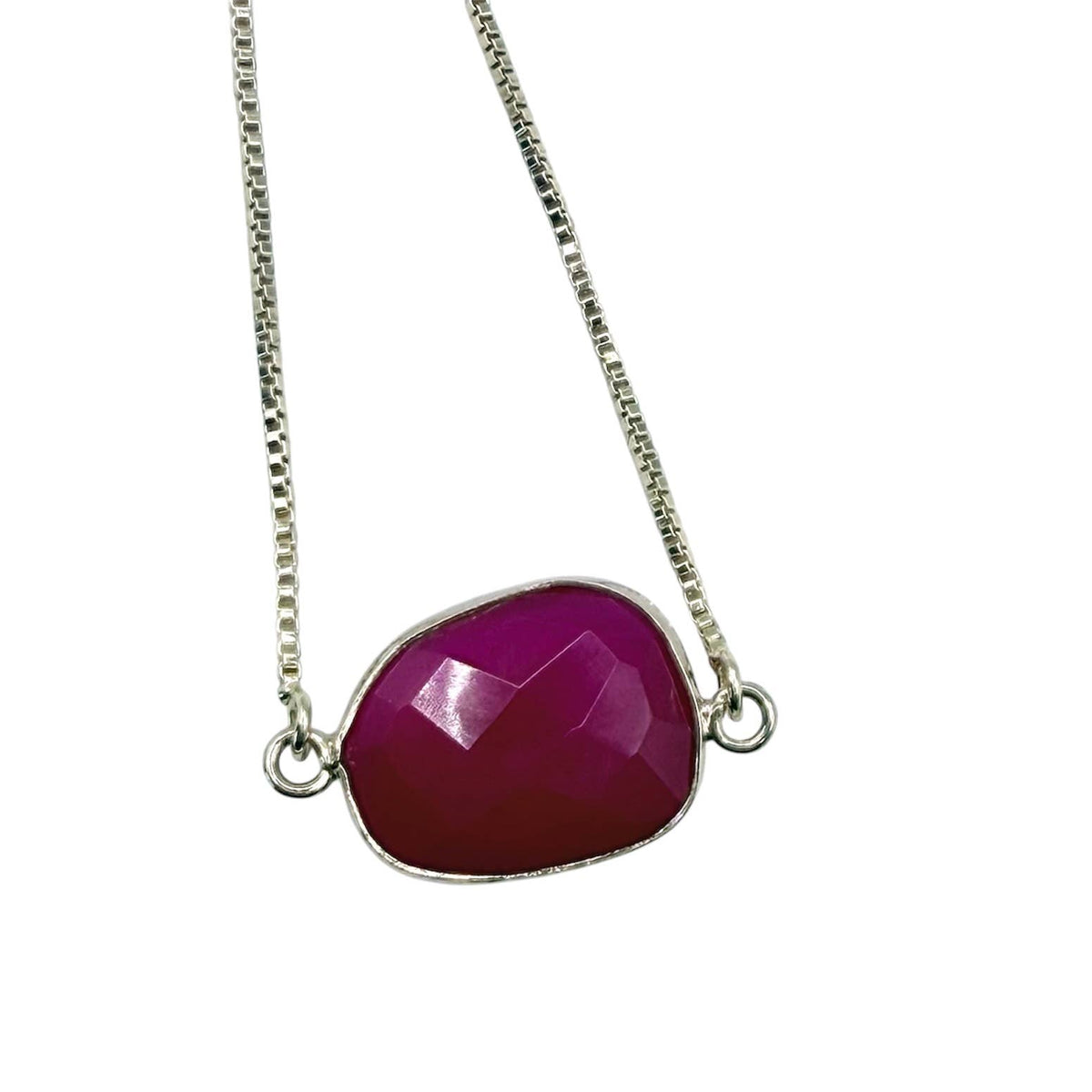 Necklace with a pink gemstone pendant on a white background