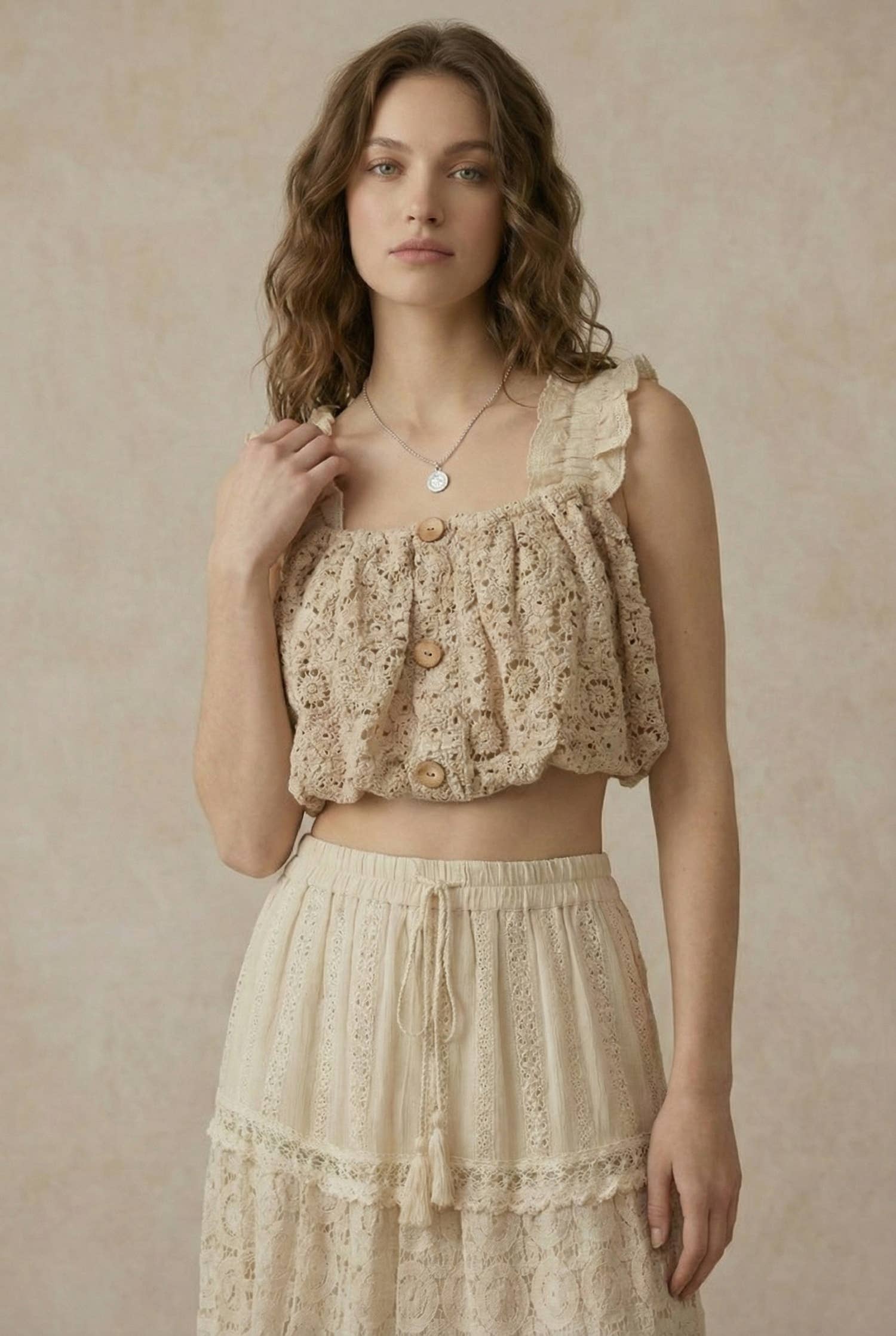 Sweet Innocence lace crop top - front view showing intricate woven lace design with button-down detailing