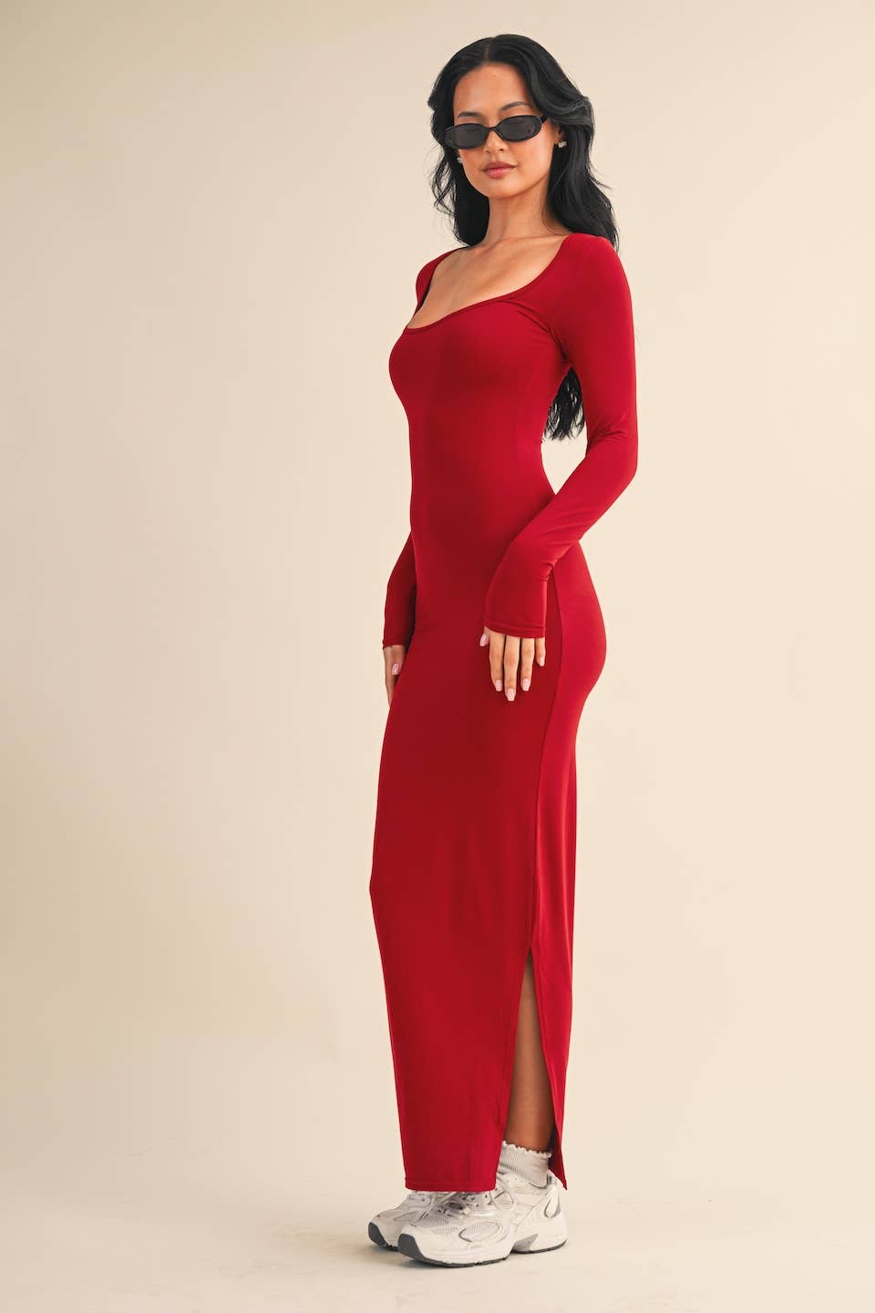 Side view Woman wearing red square-neck long sleeve maxi dress in buttery knit fabric by Kimberly C.