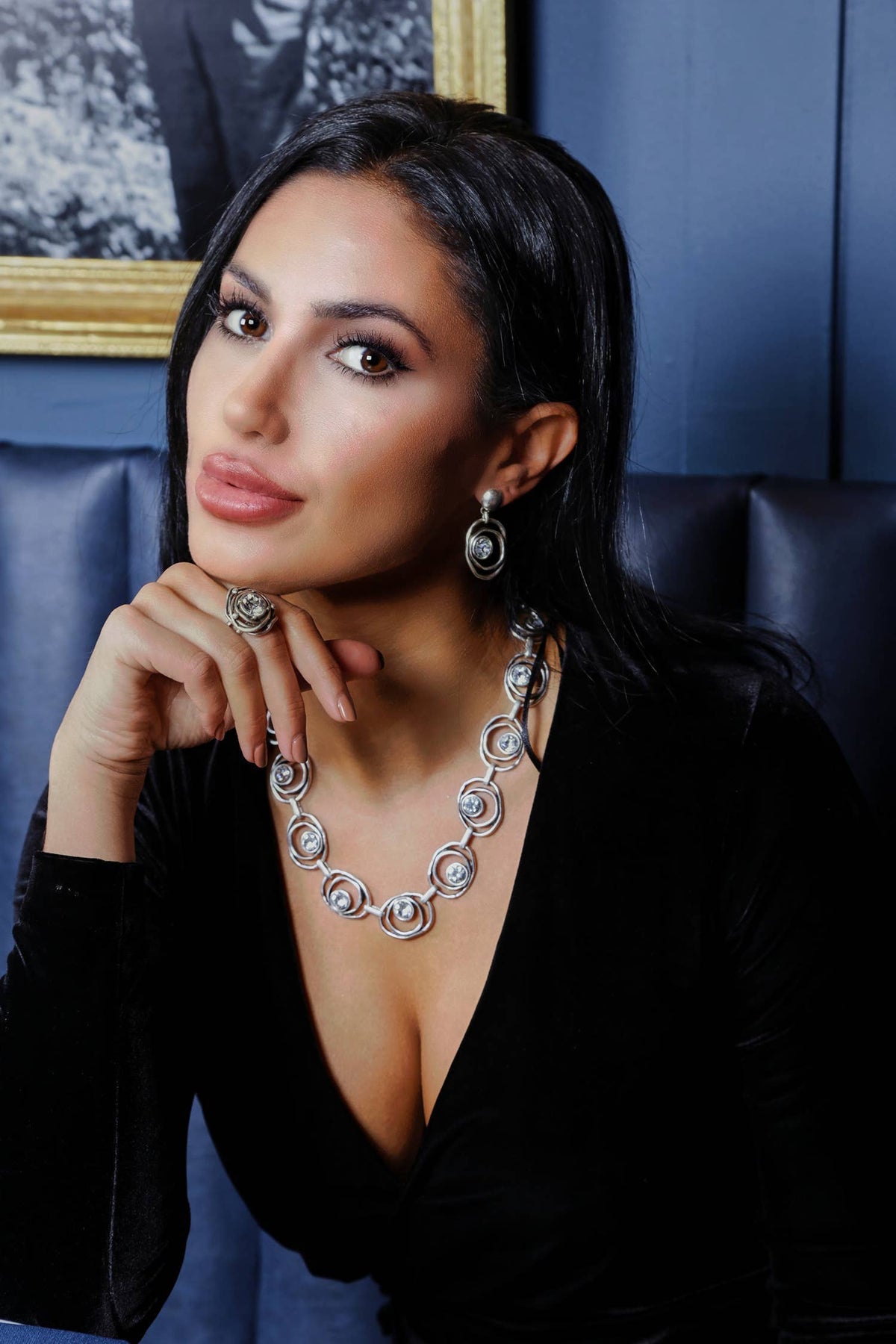 Woman wearing a necklace and earrings in a formal setting