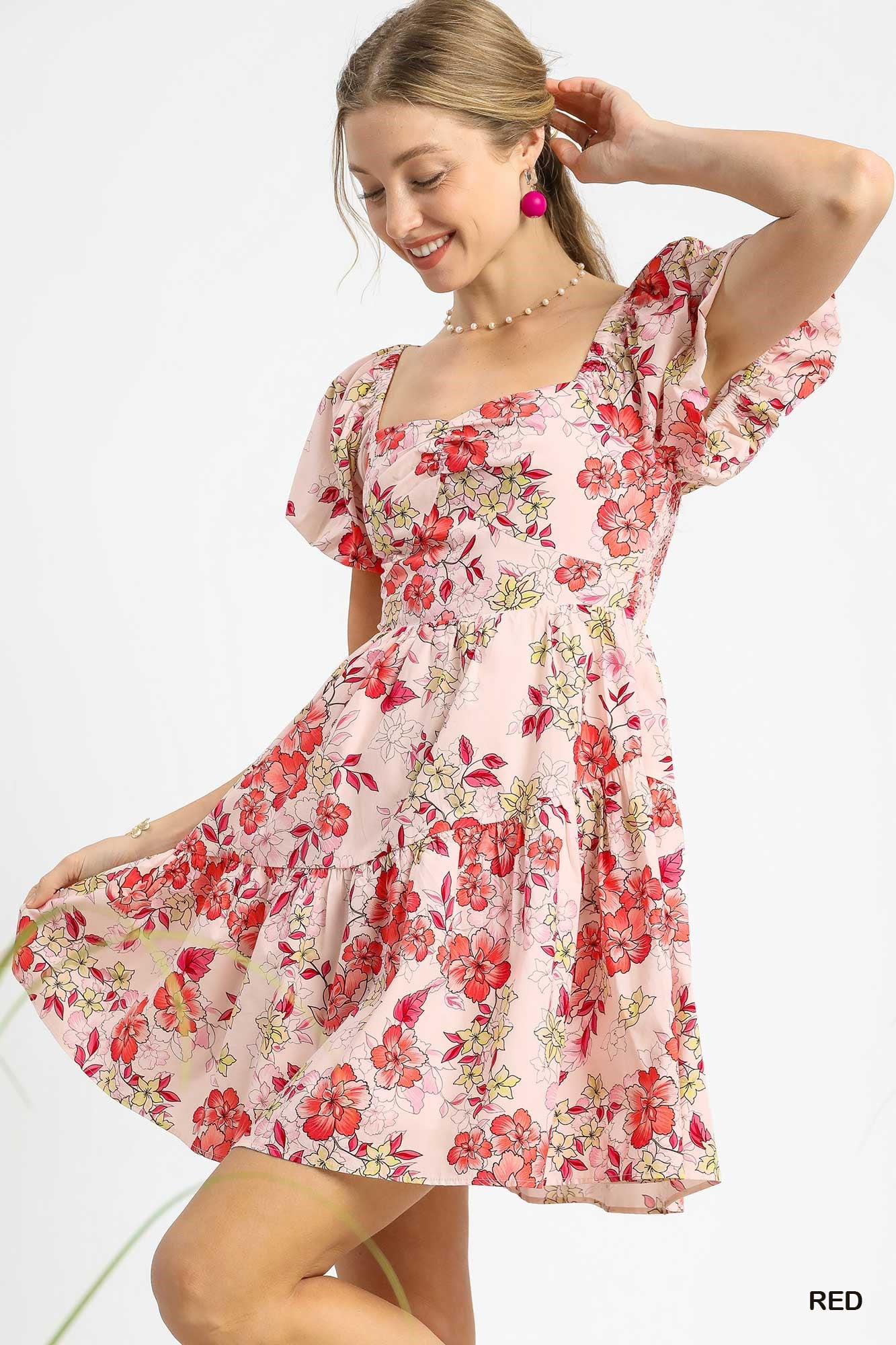 Woman wearing a floral dress on a white background