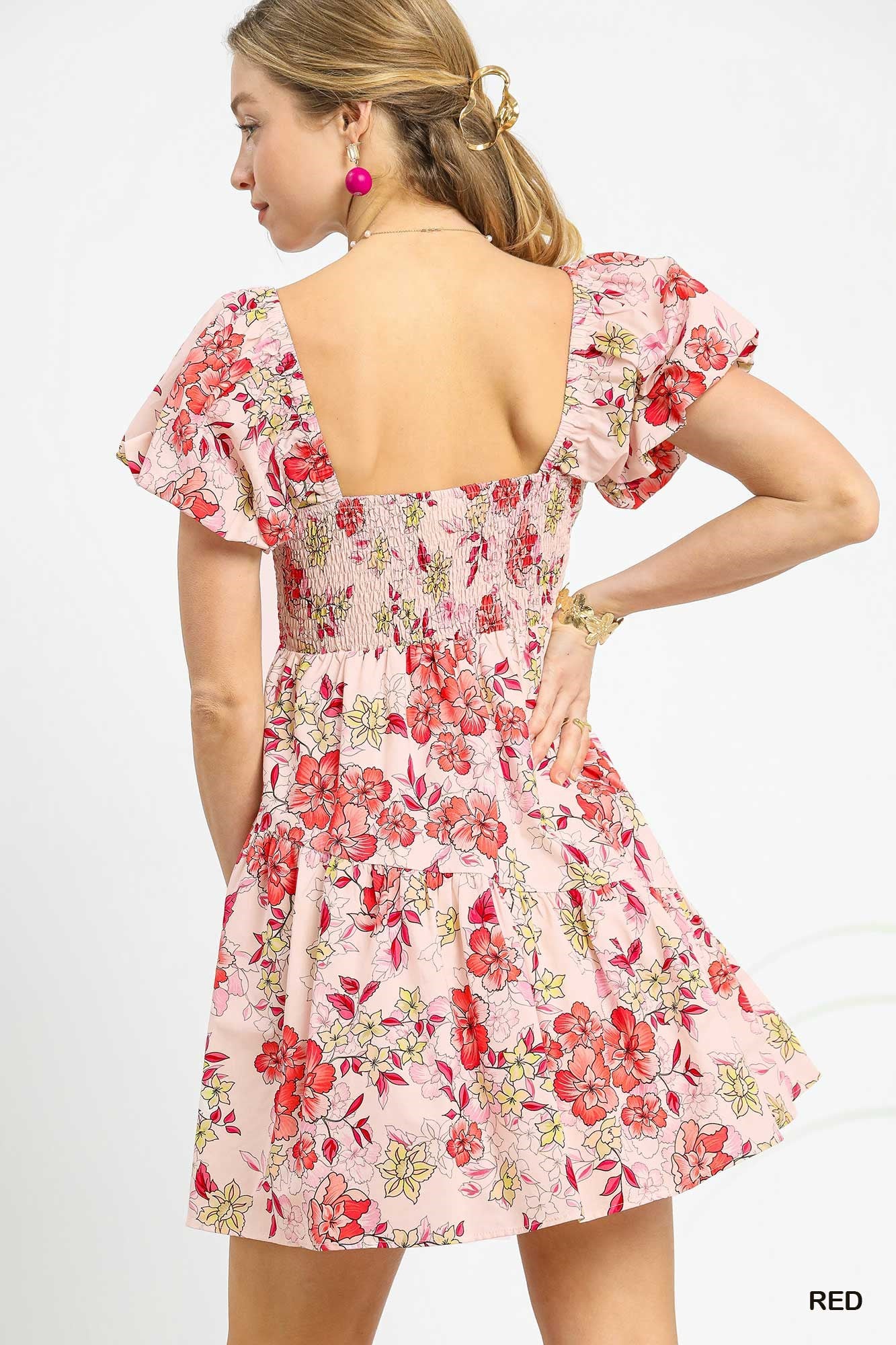 Woman wearing a floral dress on a white background