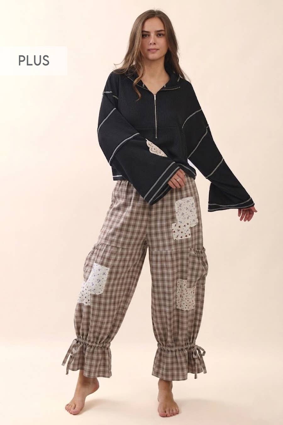 Plus size oyster grey gingham ruffle bloomer pants with floral patch pockets and cinched ruffle hem, styled with a black zip top — Spirit & Wind Boutique