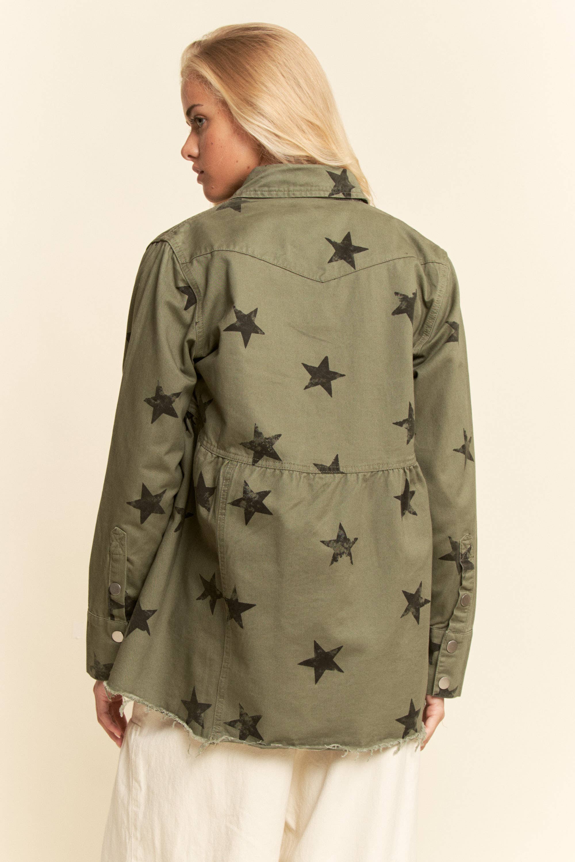 Back view- Olive star-print babydoll shacket with snap-button front, chest flap pockets, dropped shoulders, relaxed fit, and frayed curved hem.