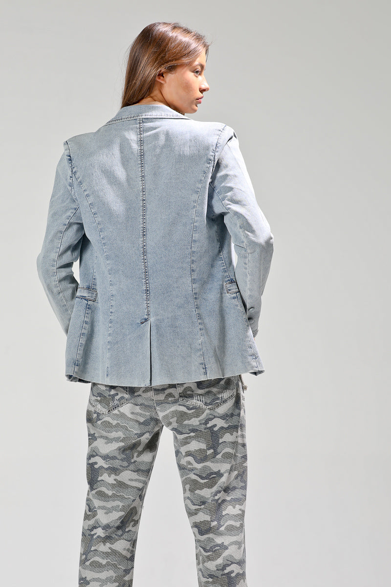 Back view of light-wash denim blazer showing structured seams, tailored waist, and single vent detail.