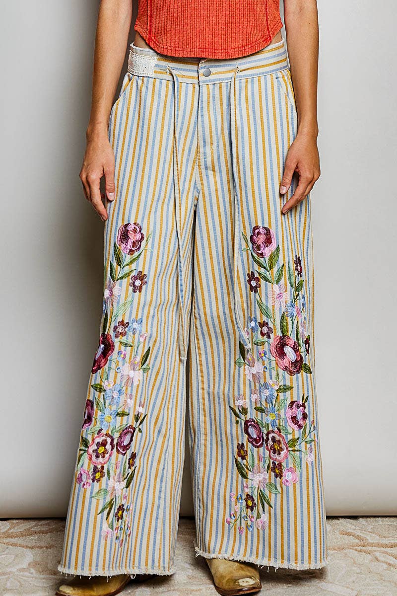 POL Clothing Marigold Revival wide-leg jeans with mustard, blue and white stripes, floral embroidery and frayed hems.