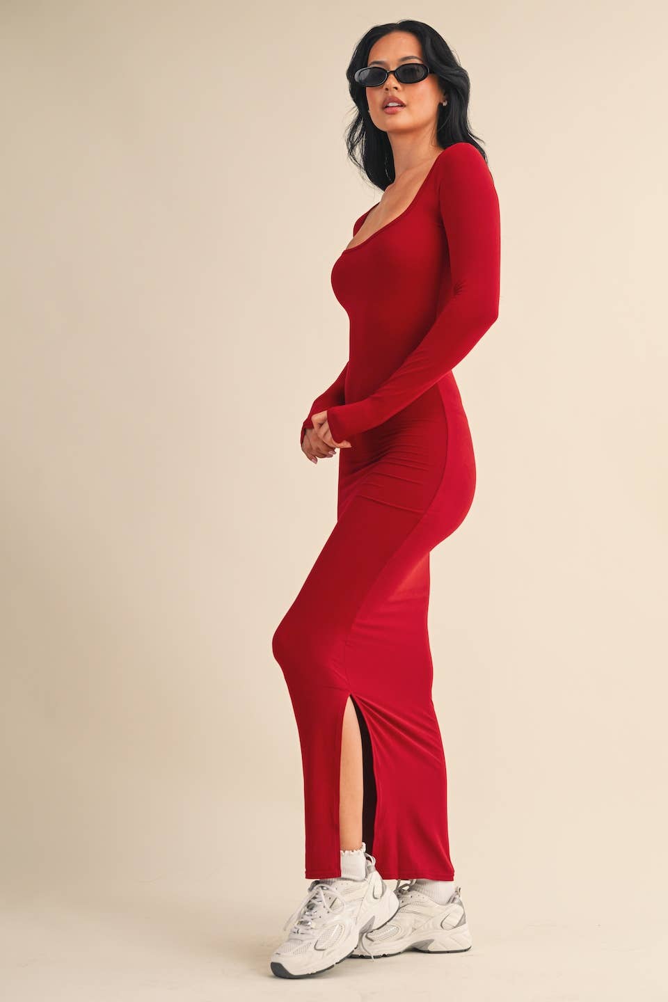 Side view of Woman wearing red square-neck long sleeve maxi dress in buttery knit fabric by Kimberly C.