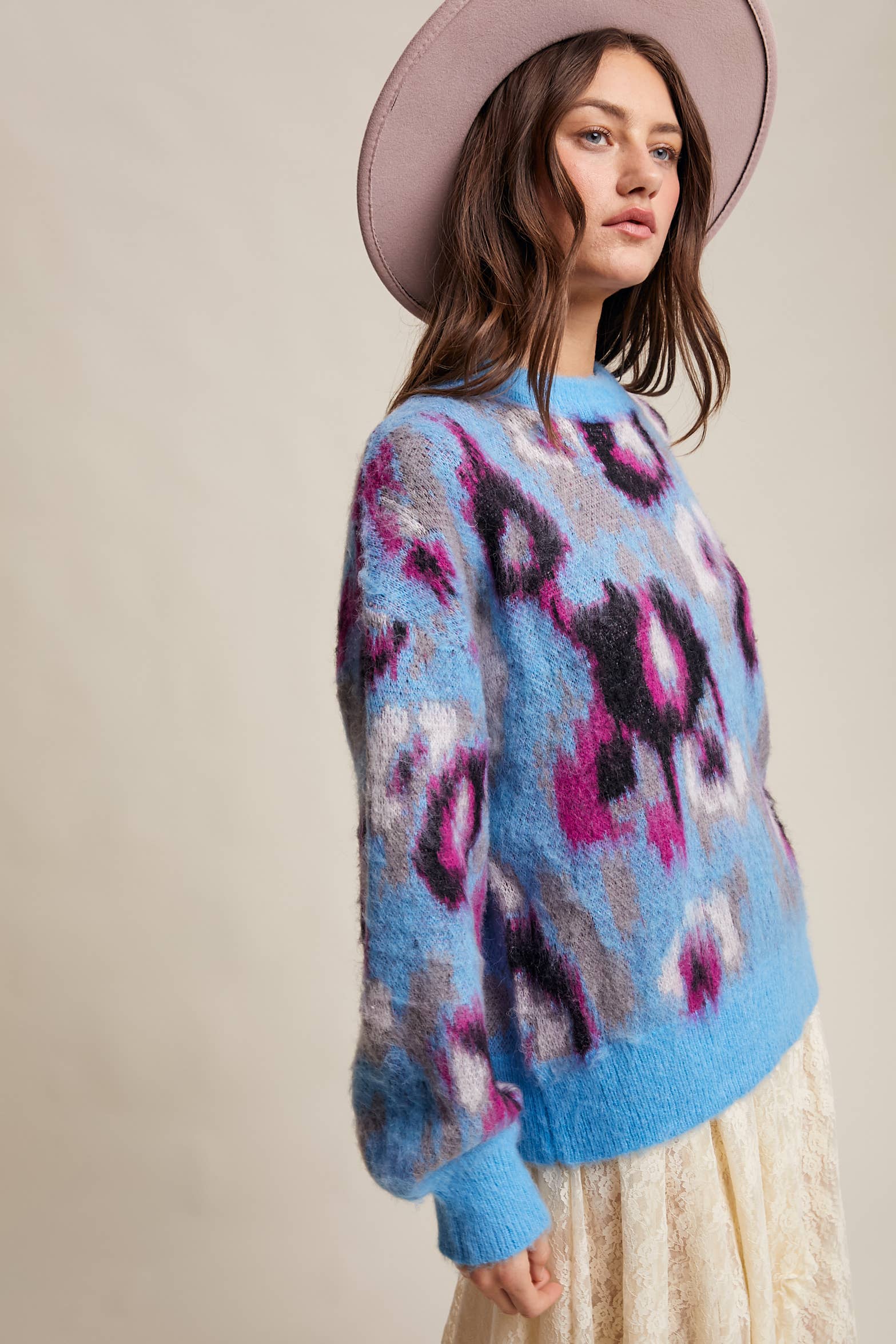 Side View Women’s fuzzy abstract leopard knit pullover sweater with soft textured fabric and bold animal print — cozy statement top for modern chic outfits.