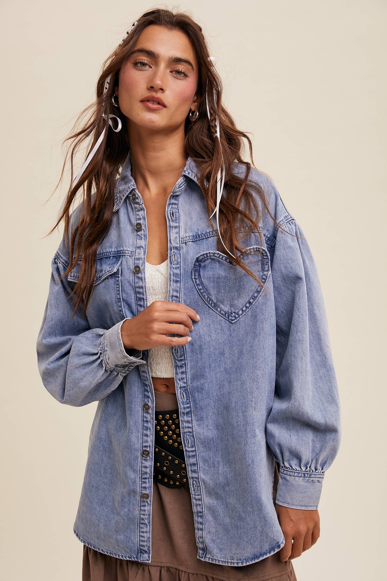 Light-wash oversized denim shacket with a heart-shaped chest pocket, button front, drop shoulders, balloon sleeves, and a curved hem.