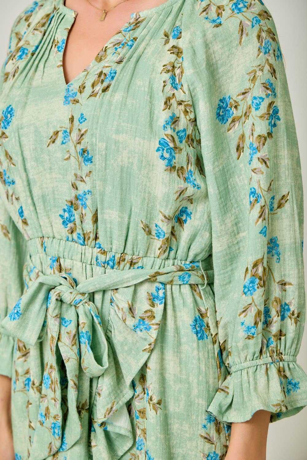 The Valencia Floral Wrap Dress - close-up of floral print and ruffle details on 100% cotton fabric