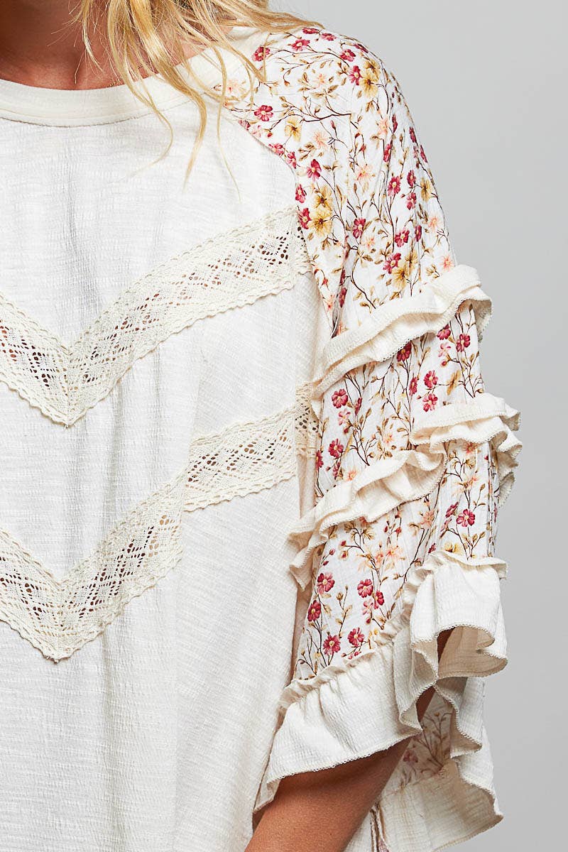 Tina's Boho Floral Lace Top in Natural – close-up detail of cream crochet lace chevron trim and tiered pink floral ruffle sleeve