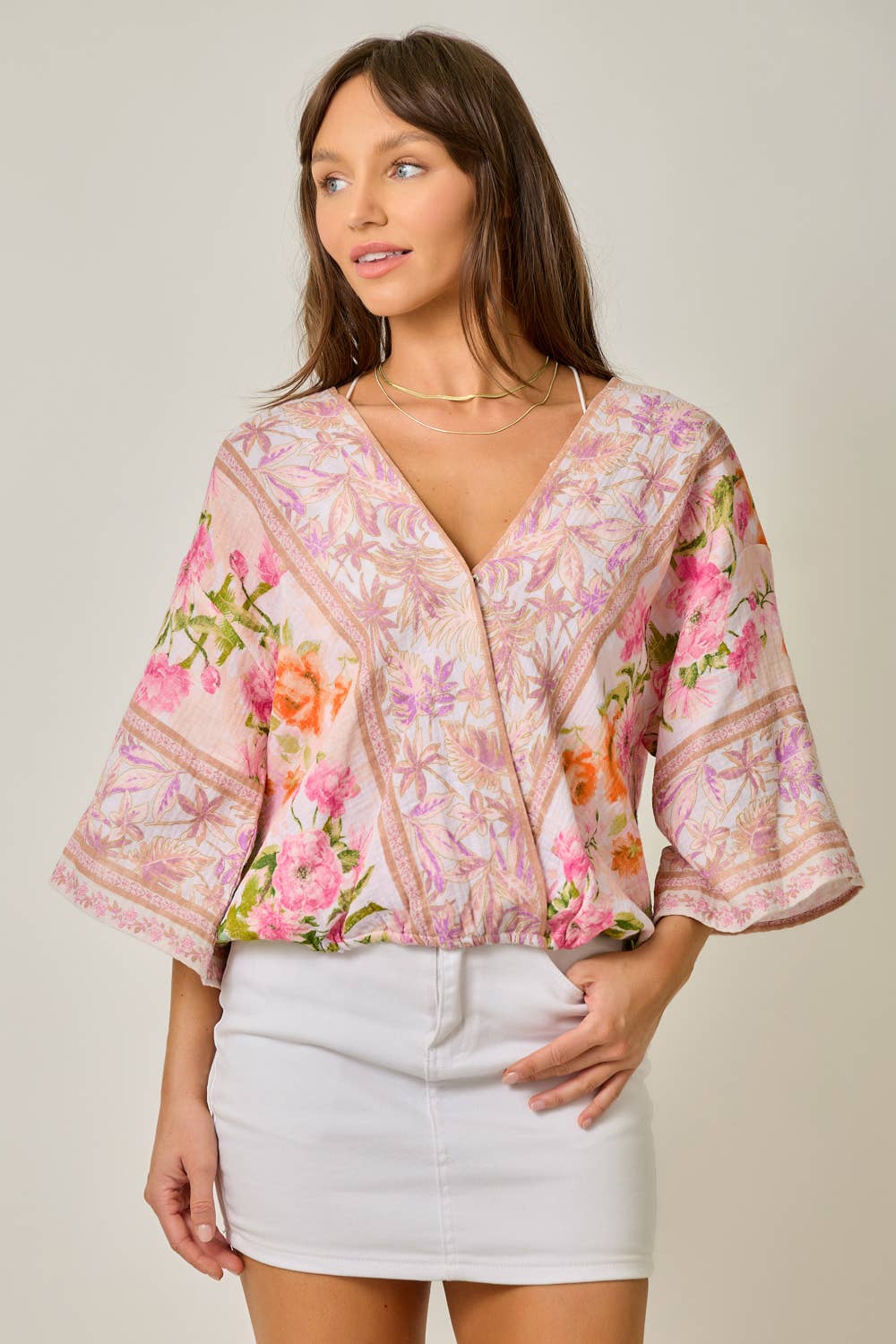 Woman wearing a floral blouse with a plain background
