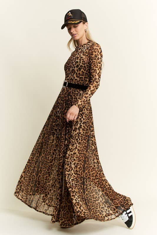 Side view of a leopard-print long-sleeve mesh maxi dress with a sheer, flowy skirt, styled with a black belt, baseball cap, and black-and-white sneakers.