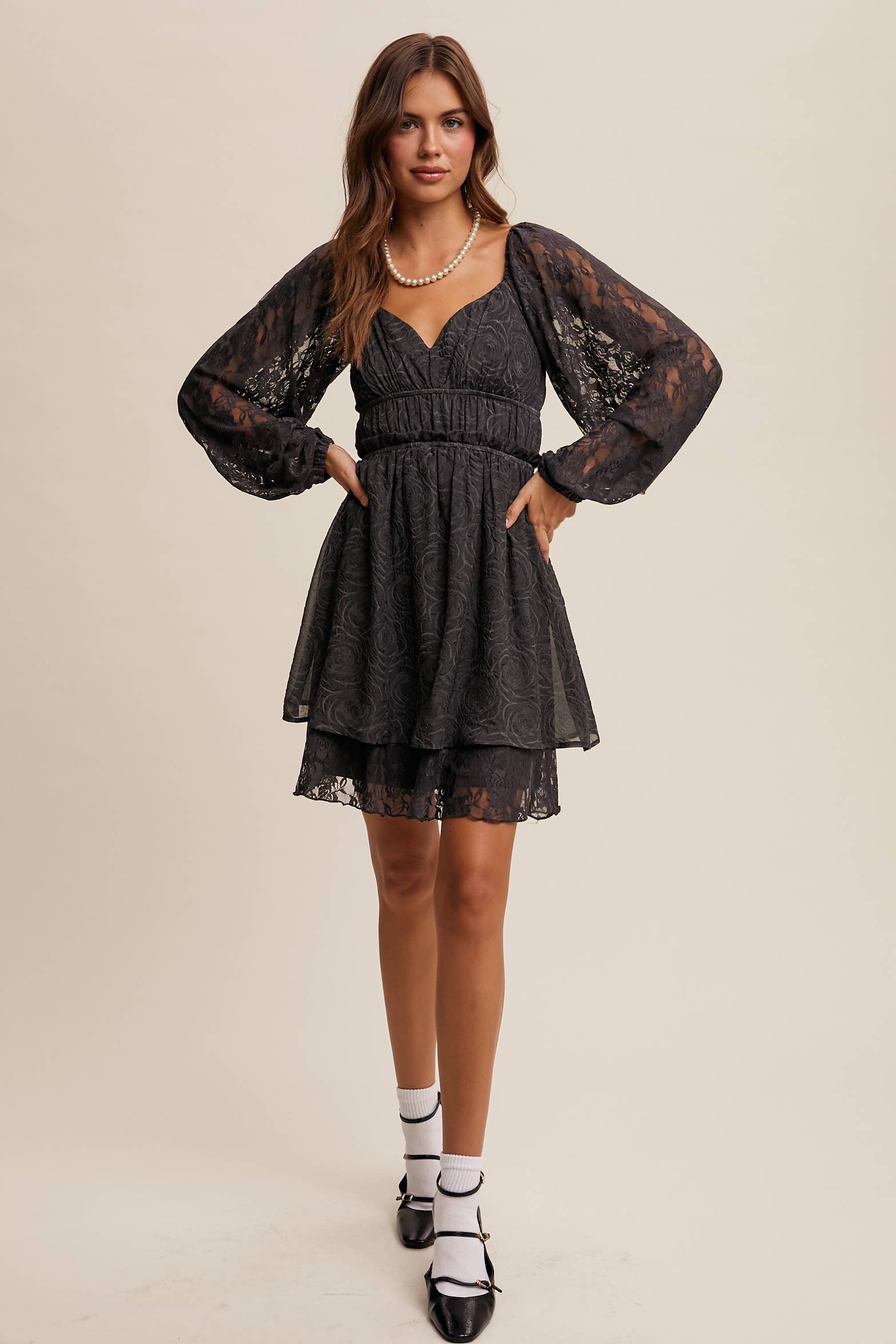 Model wearing The Midnight Lace Dress with sweetheart neckline and sheer lace sleeves