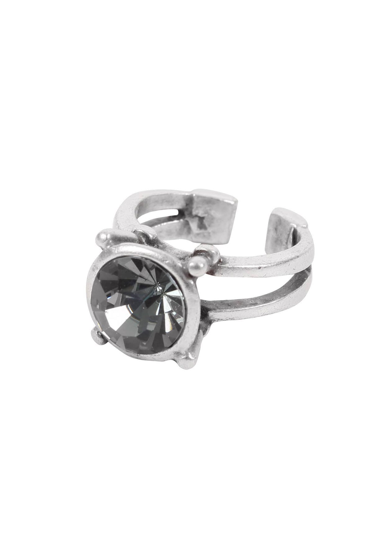 Silver ring with a central gemstone on a white background
